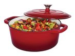 A red cast iron Dutch oven filled with vegetables, with the lid slightly ajar.