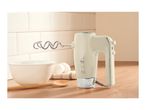 Retro-style cream hand mixer with dough hook on a wooden countertop next to a mixing bowl