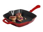 Red cast iron grill pan with two grilled steaks, red onions, mushrooms, and rosemary.