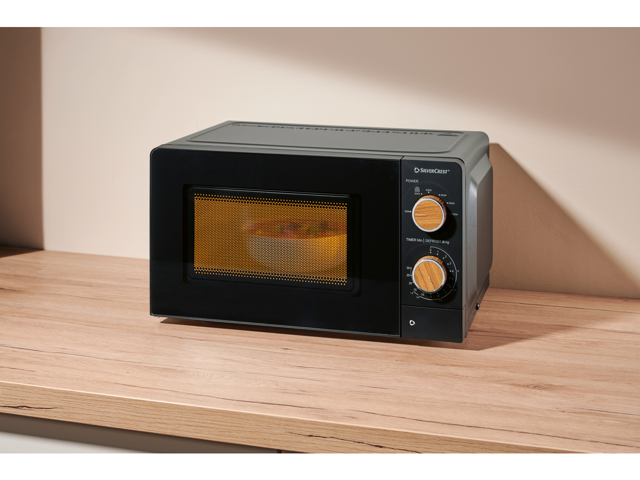 SILVERCREST® 700W Microwave on a wooden countertop.