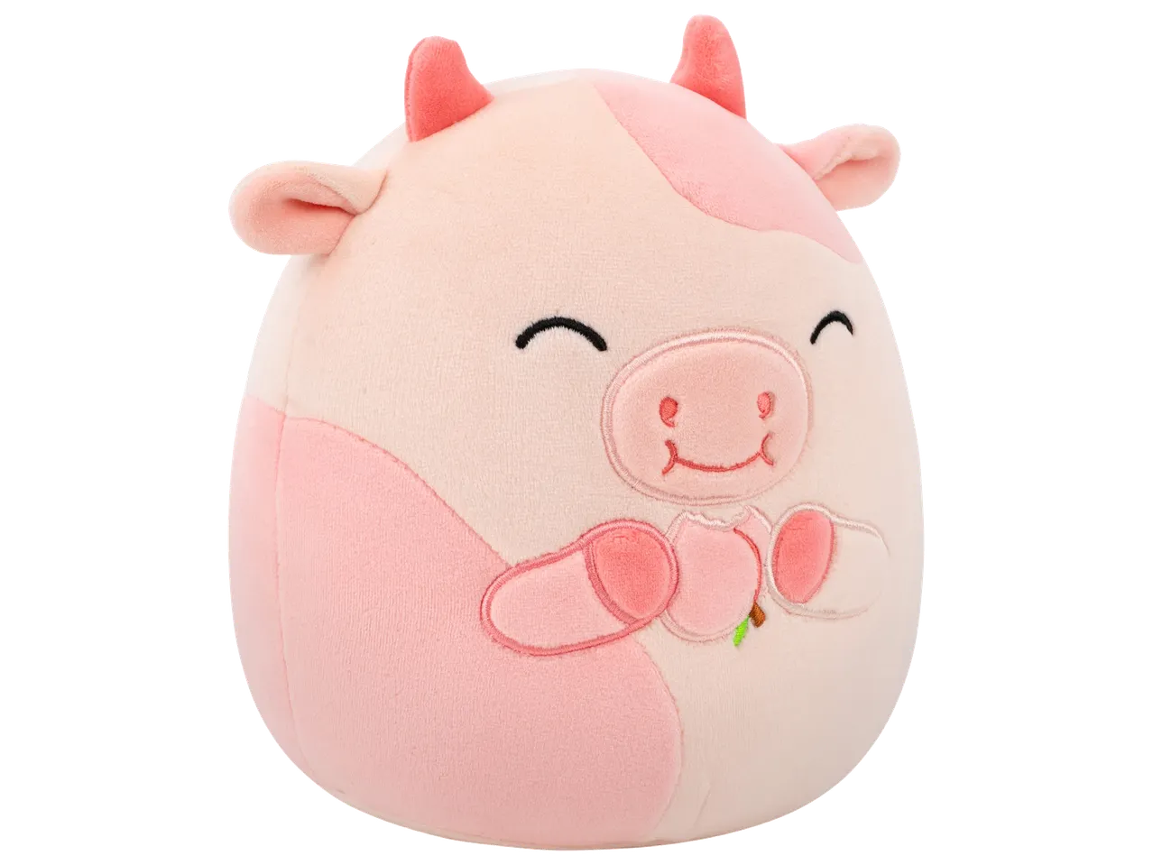 Peluche de vache rose et blanche avec des cornes roses et un visage souriant.