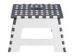 A gray and white polka-dotted foldable plastic step stool.