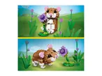 Two views of a toy hamster made from building blocks, one sitting and one lying down, in a grassy field with flowers.