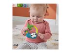 Baby playing with a colorful sloth-themed rattle on a patterned rug.