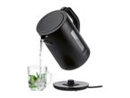 A black stainless steel electric kettle pours water into a glass.