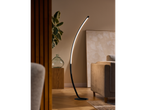 A modern arc floor lamp illuminates a living room with a beige sofa and wooden accents.