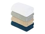 A stack of four soft, fluffy towels in white, gray, beige, and navy blue.