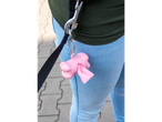 KARLIE Poop Bag Holder in pink, attached to a leash, worn by a person in jeans.