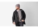 Man in a black rain jacket, grey sweatshirt, and grey beanie.