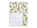 White fabric with a vibrant lemon and leaf pattern, partially folded to reveal a subtle leaf print.