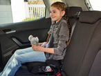 Child in a car booster seat.
