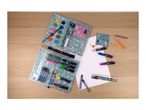 Two art supply sets, including watercolors and colored pencils, alongside drawing paper.