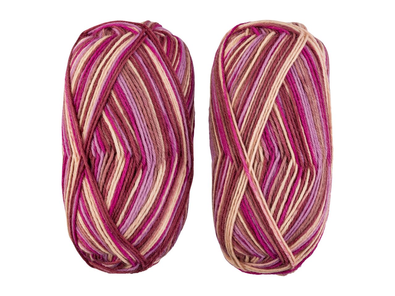 Two skeins of variegated yarn in shades of pink, purple, and beige.