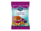 Purple and teal bag of caramelised cashew nuts with a bowl of nuts and loose cashews.