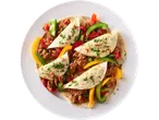 Four soft tacos filled with seasoned ground meat and bell peppers on a white plate.