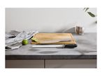 A ceramic knife sharpener and a chef's knife on a wooden cutting board with limes.