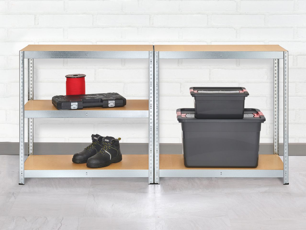 Two metal shelving units with various items, including work boots, a tool case, and storage boxes.