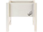 A white wooden planter box with two black leaf designs on the front.