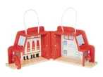Red wooden toy fire station playset with handles, open to show interior details.