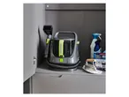 Daewoo carpet cleaner and cleaning supplies stored in a grey cabinet.