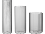 Three clear ribbed glass vases of varying heights and widths on a black background.