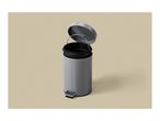 Grey pedal bin with an open lid and a black inner bucket, on a beige background.