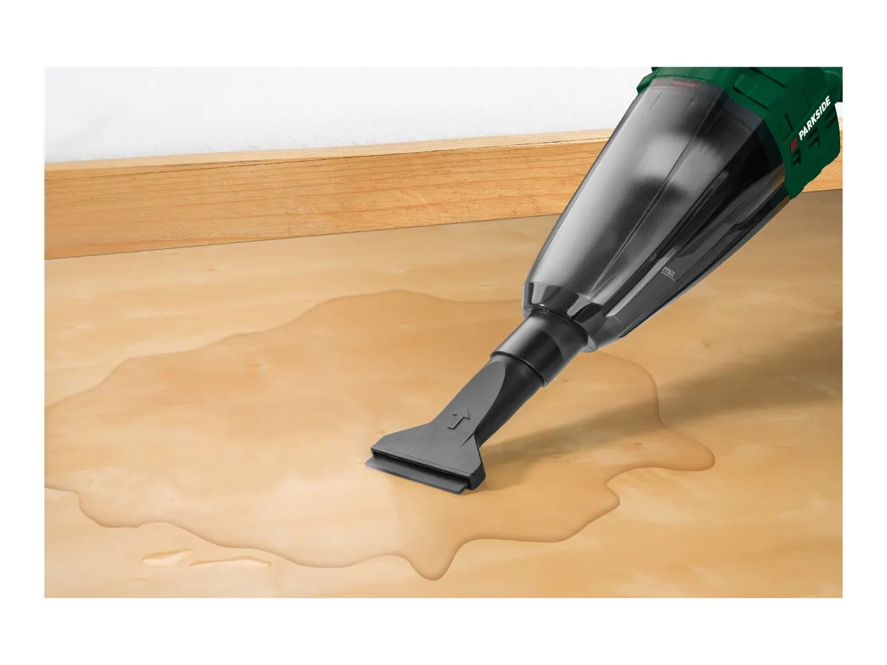 Parkside wet and dry vacuum cleaner cleaning a liquid spill on a wooden floor.