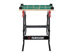 A black and green Parkside workbench with a wooden top and red handles.