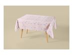 Pink floral tablecloth on a wooden table with a light background.