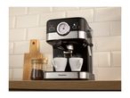 Espresso machine brewing coffee into two white cups on a wooden counter.