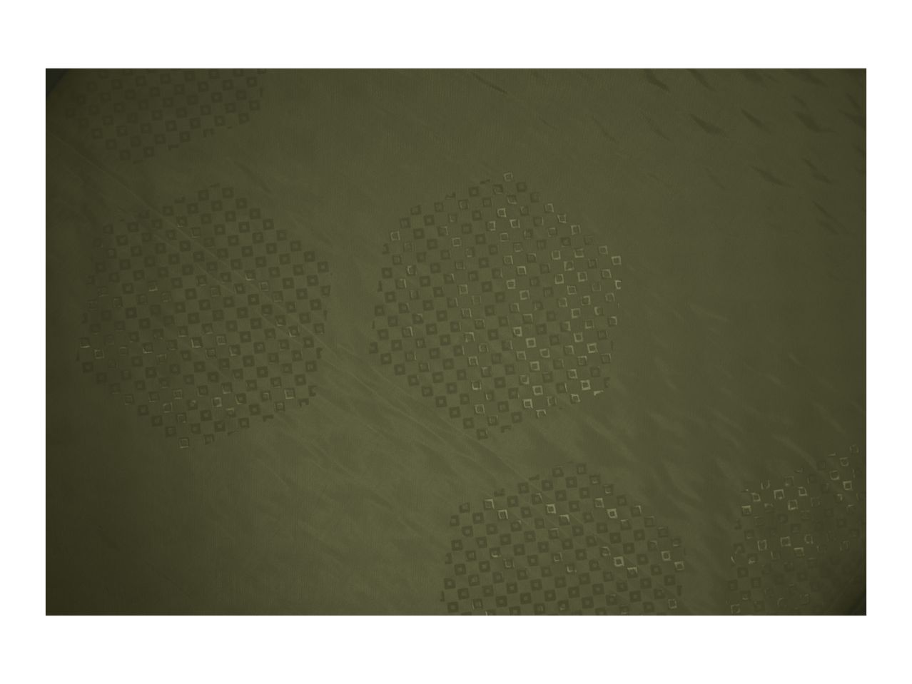 Close-up of a dark green fabric with a subtle square pattern and textured surface.
