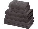 Stack of dark grey folded towels, including bath and hand towels.