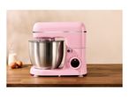 A pink SilverCrest stand mixer with a stainless steel bowl on a wooden counter.
