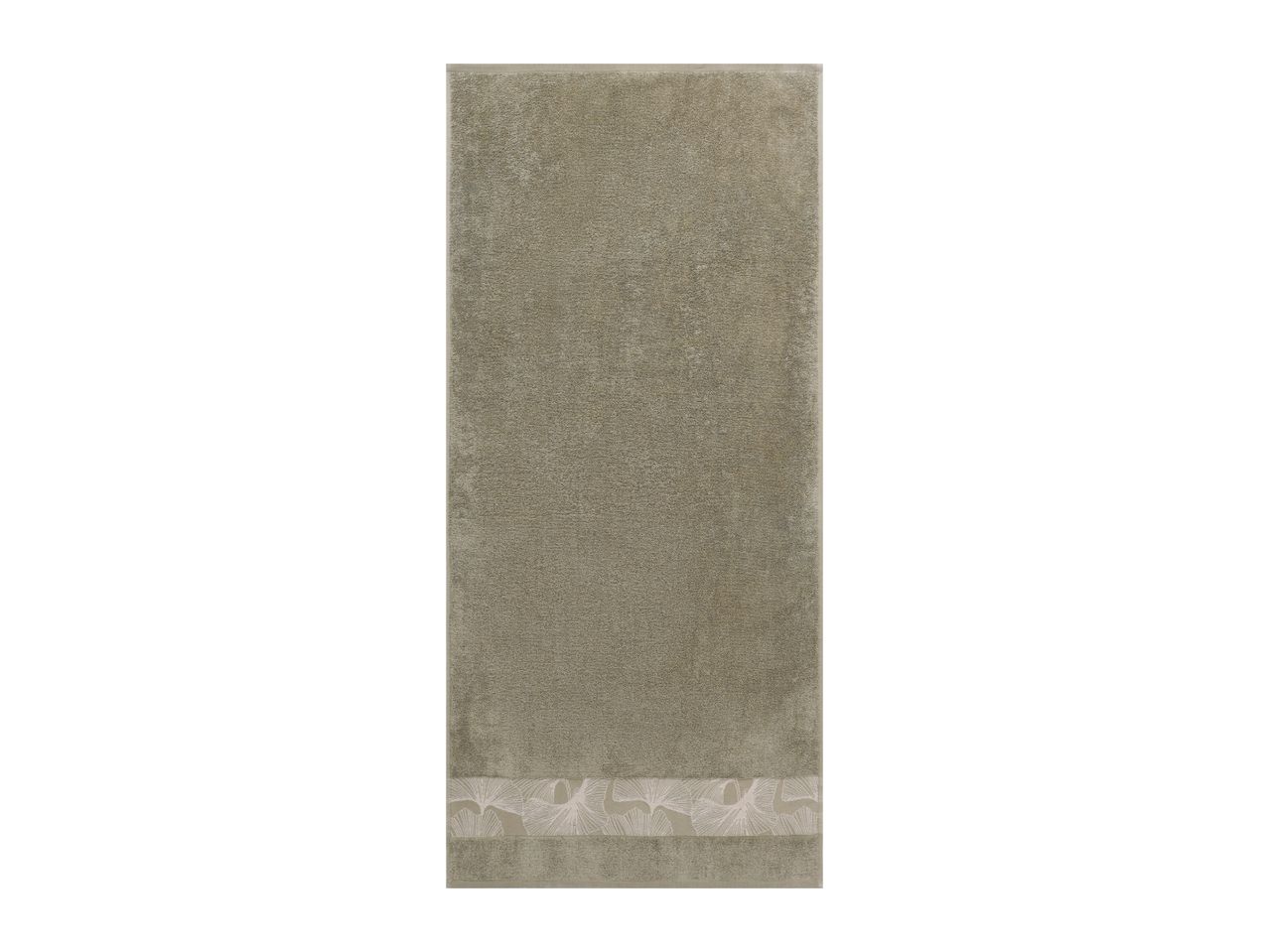 Green towel with a decorative floral border at the bottom