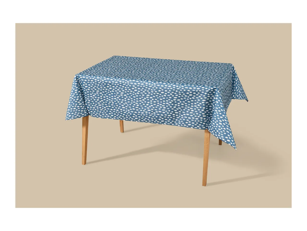 Blue tablecloth with white polka dots on a wooden table.