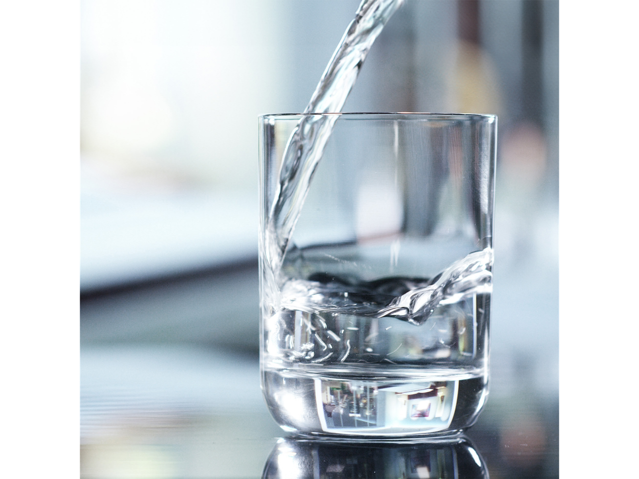 Clean water pouring into a glass.