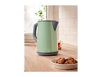 A light green electric kettle on a wooden kitchen counter with cookies and tea.