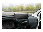 Charcoal air purifying bag on a car dashboard with a blurred outdoor background.