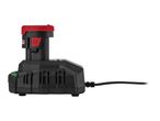 A black battery charger with a red and black battery pack inserted, showing a green light.
