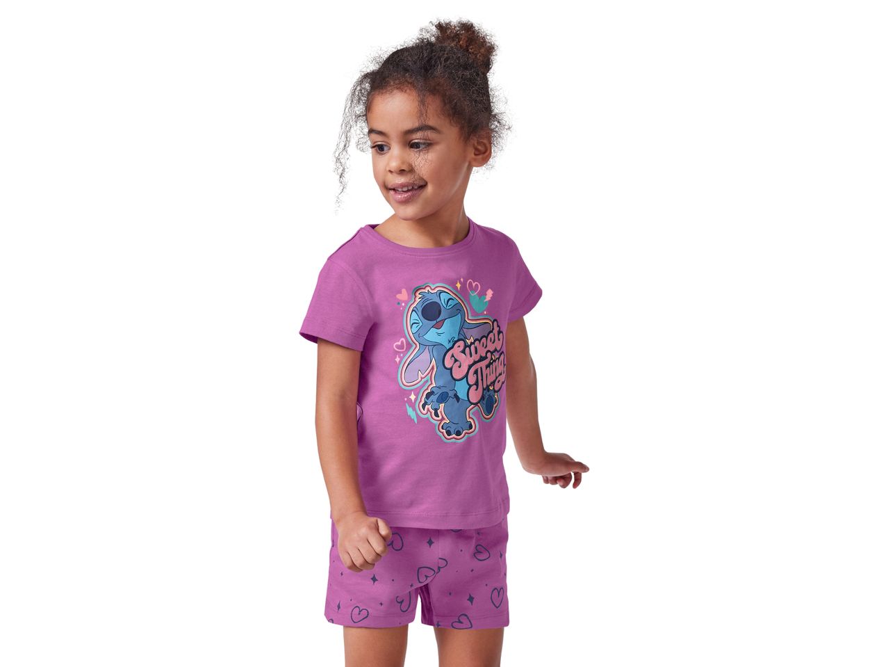 Girl wearing a purple Stitch pajama set.