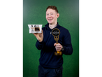 Man holding a 'Great Taste 2017' award and 'The Smokin' Butcher' black pudding.
