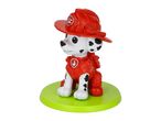 A dalmatian dog figurine wearing a red firefighter helmet and uniform, standing on a green base.