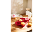 SILVERCREST® silicone baking assortment with a red muffin tray and cupcakes on a wooden surface.