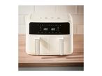 Cream-colored dual air fryer with digital display showing 180 degrees Celsius.