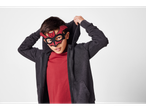A boy wearing a red and black felt bat mask and a dark gray hoodie.