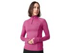 A woman in a pink long-sleeved athletic top with a quarter-zip and thumbholes.