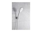 Chrome handheld showerhead spraying water, mounted on a grey tiled wall.