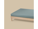 Livarno Jersey Fitted Sheet in light blue on a wooden bed frame.