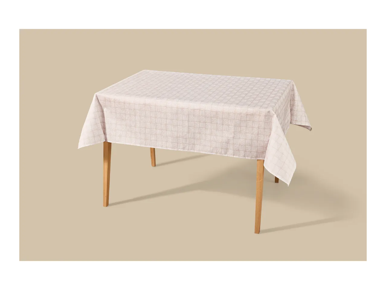 Rectangular table with a light-colored tablecloth featuring a subtle geometric pattern.