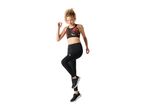 Woman in a black and red patterned sports bra and black leggings, mid-stride.